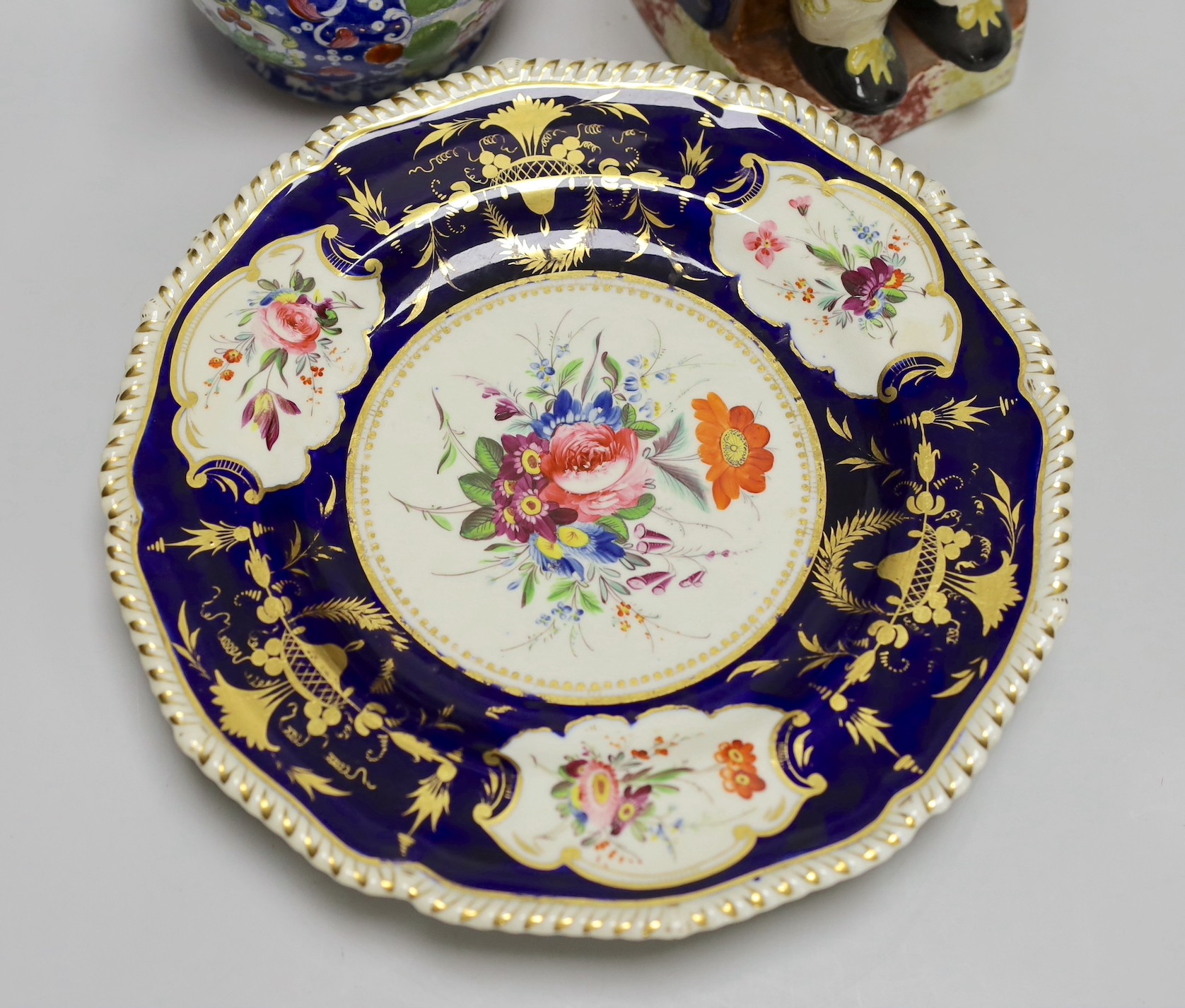 A pair of Derby plates, c.1820, an opaque china jug and a Toby jug. Tallest 24.5cm